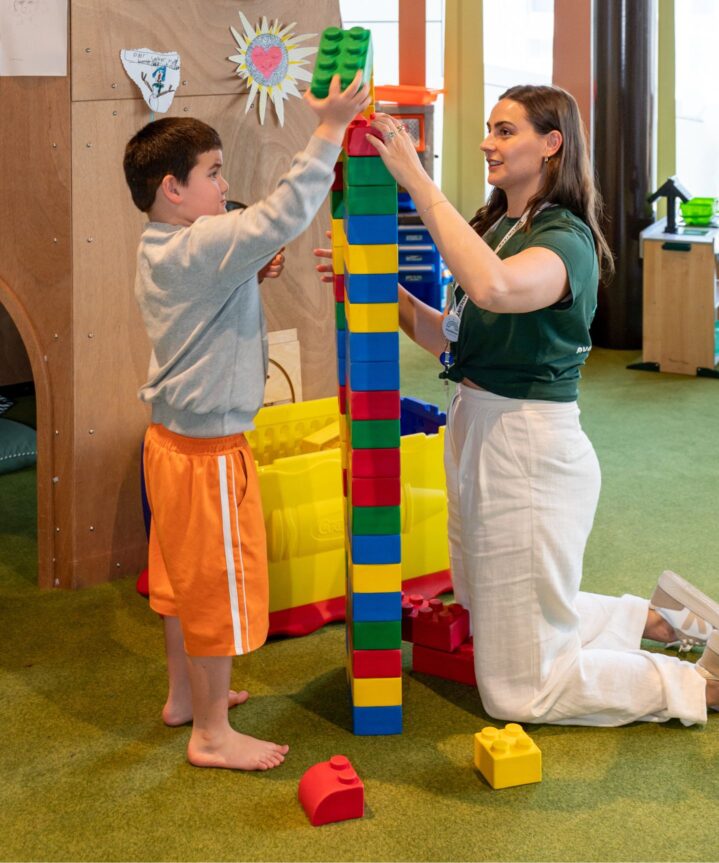 Children's Hospital Foundation Volunteer in Kidzone with a Patient