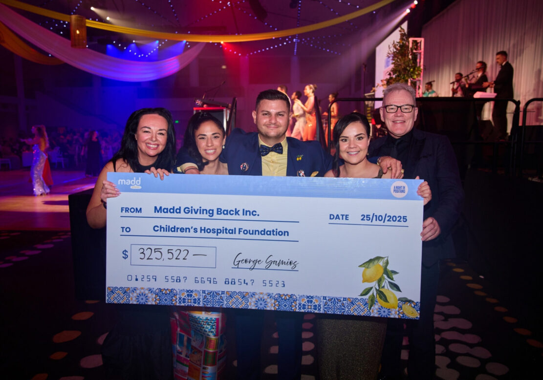 George Samioas, Frank Tracey, Lyndsey Rice and guests hold Madd Ball fundraising cheque