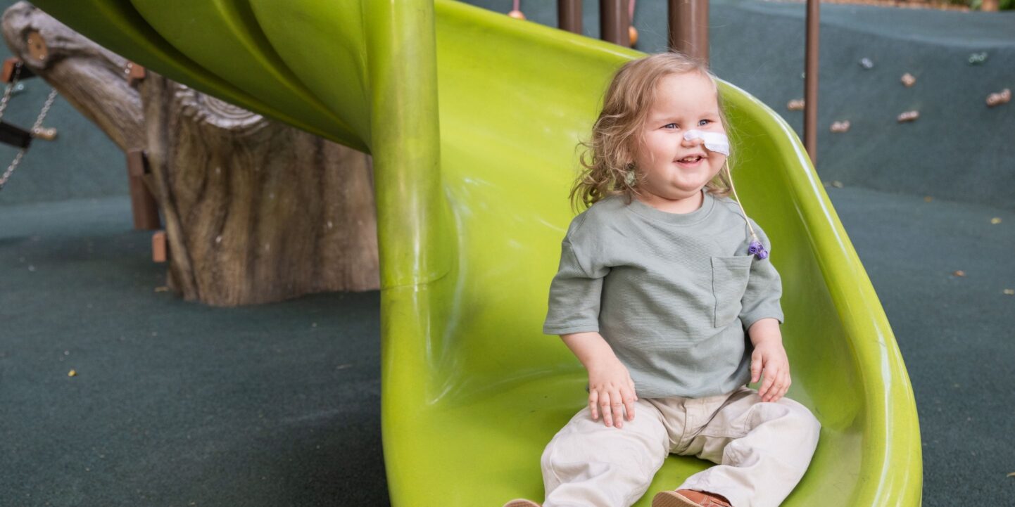 Lachlan sits on Queensland Children's Hospital playground slide