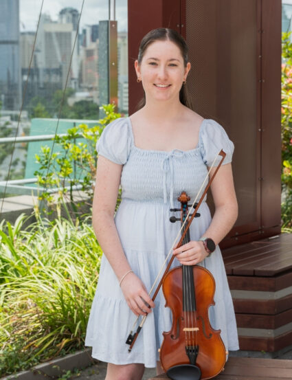 Lucy, 14, with her violin in the Queensland Children's Hospital garden