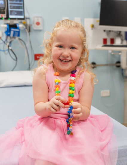 Nevaeh, 4, in a treatment room wearing her bravery beads